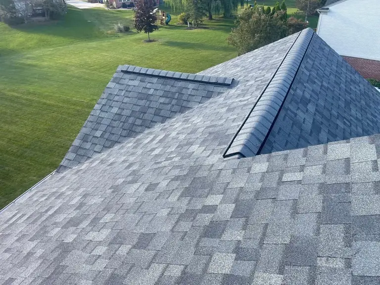 Close-up of an architectural shingle roof with a ridge vent