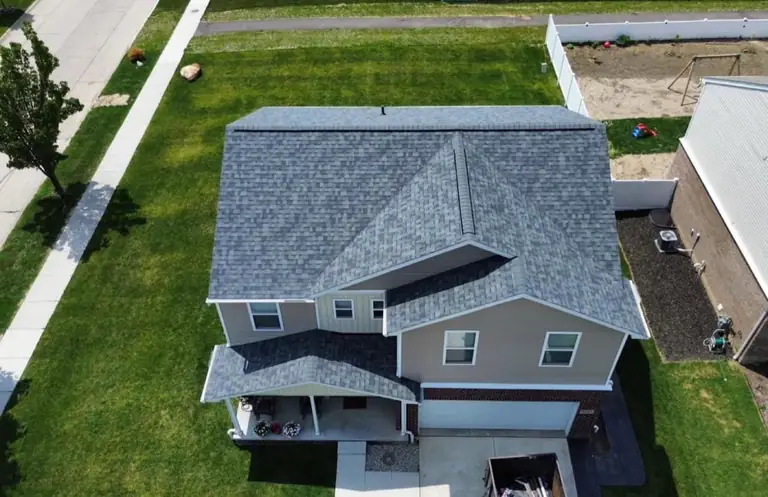 Two-story home with clean siding and an architectural shingle roof